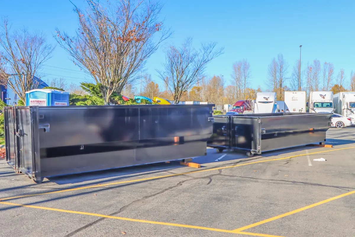 Professional dumpster rental service with roll-off container on residential driveway in Ogden